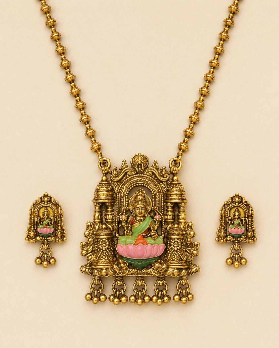Close detail of brass Lakshmi pendant and matching earrings