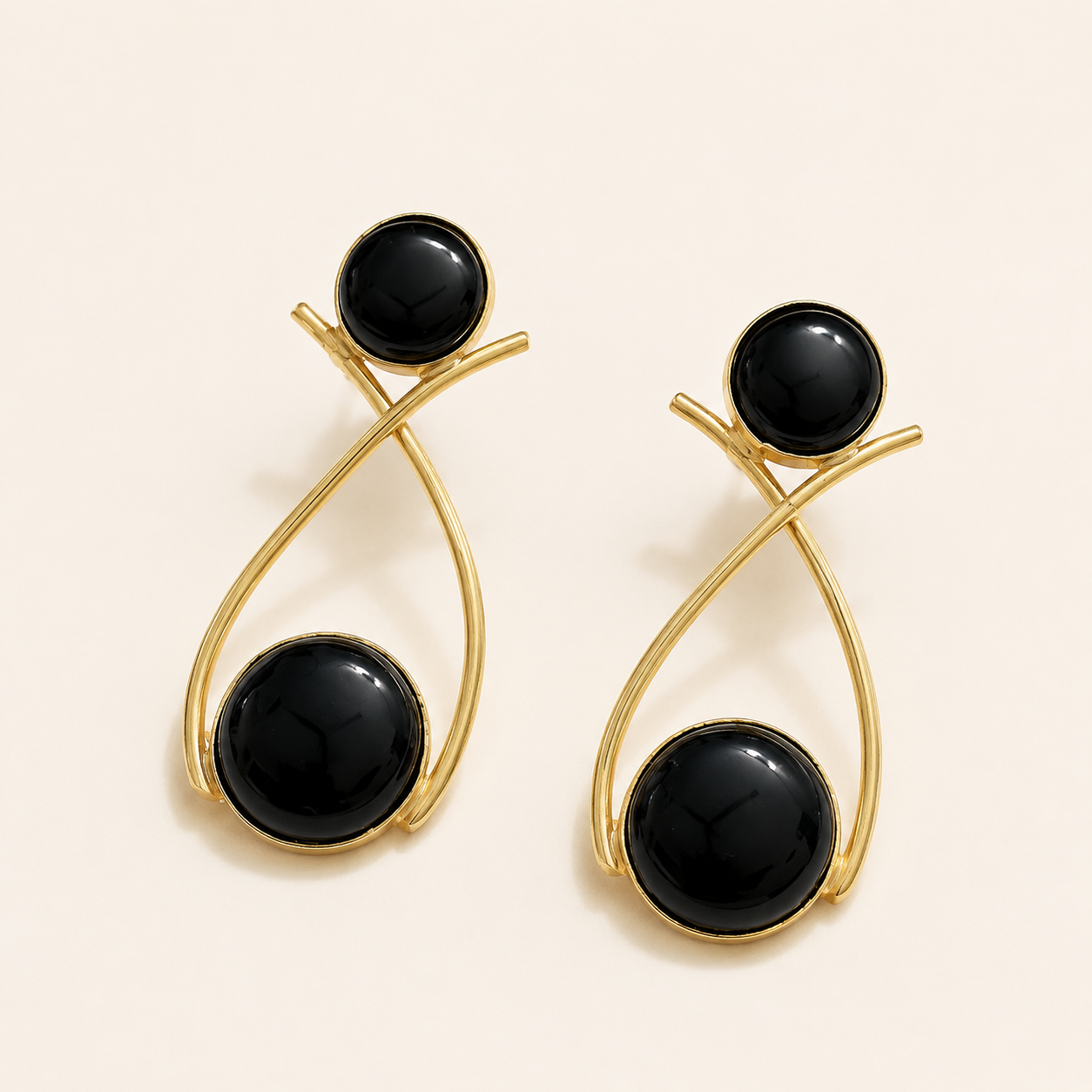 Black brass double-circle loop earrings on ivory