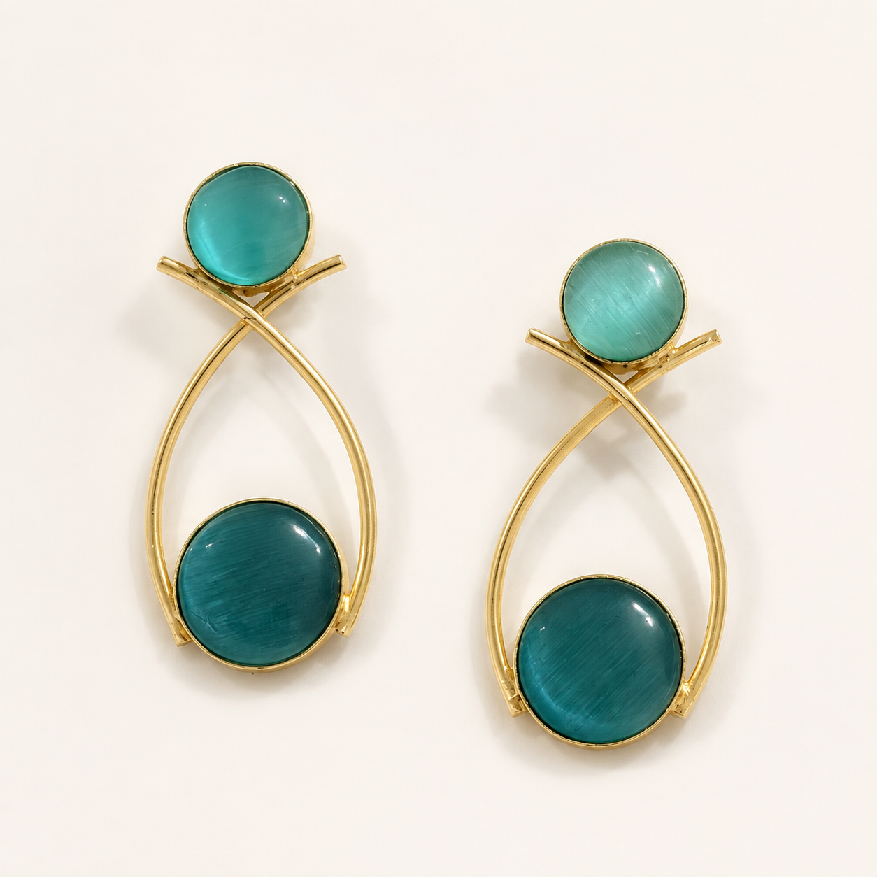 Teal brass double-circle loop earrings on ivory