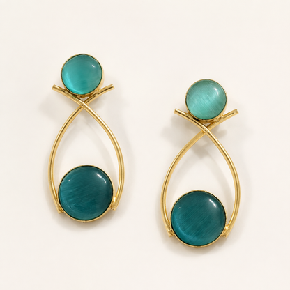 Teal brass double-circle loop earrings on ivory