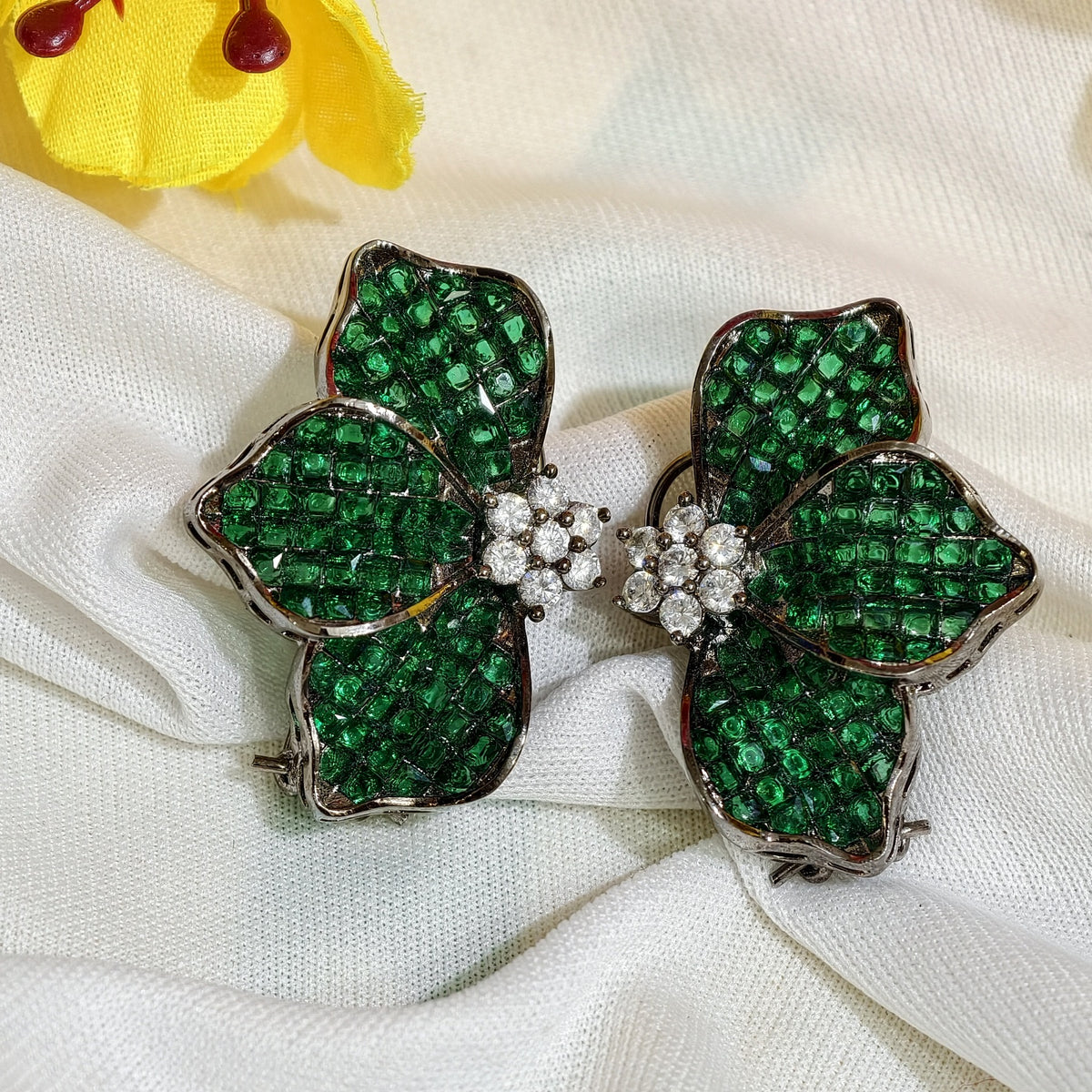 Close-up of Emerald Green Nano Setting AD half flower Stud Earrings
