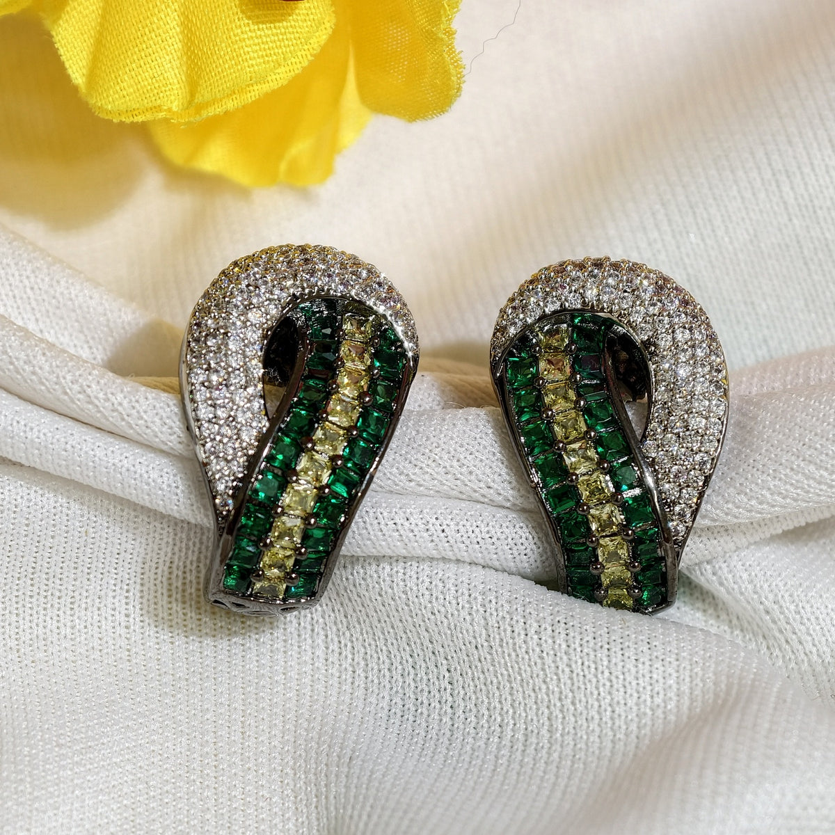 Close-up of Emerald Green Nano Setting AD Huggie Earrings