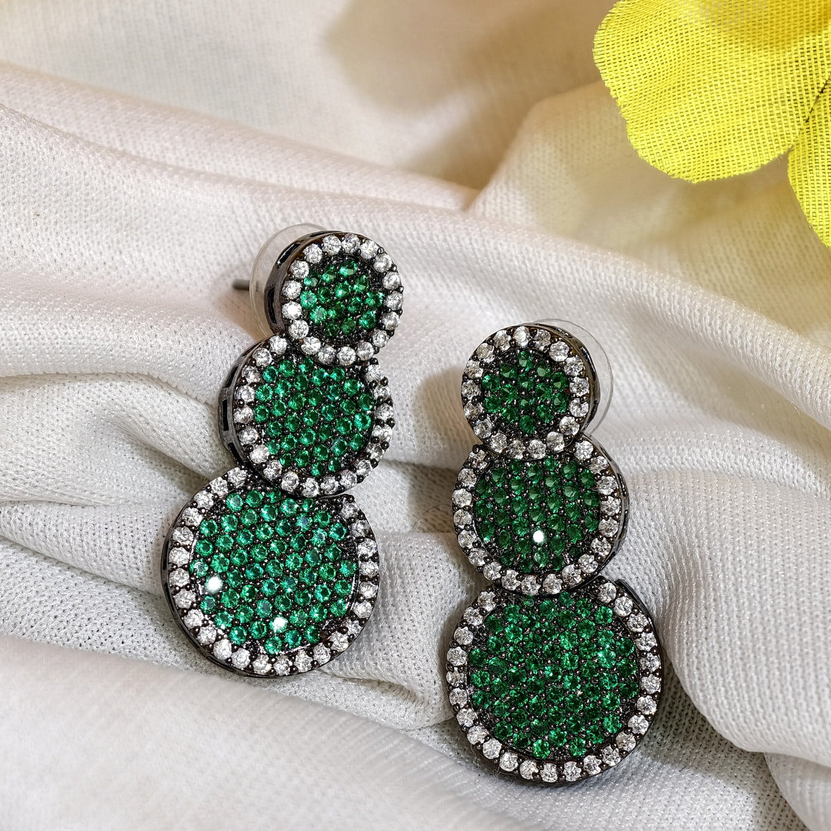 Close-up of Emerald Green Nano Setting AD Triple Round Drop Earrings