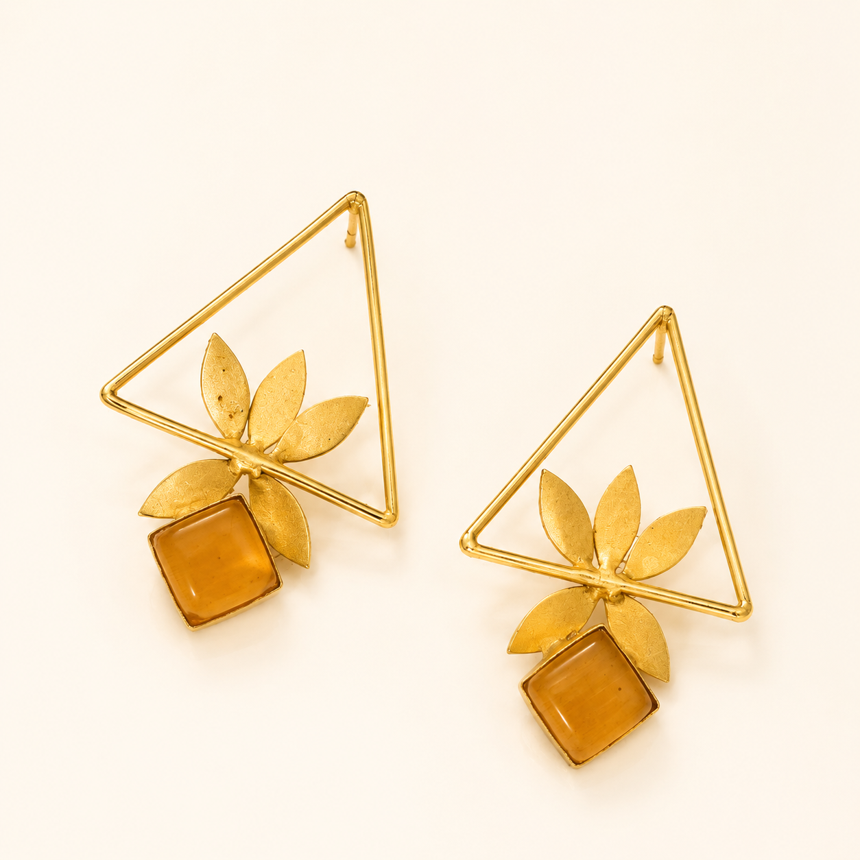 Amber brass geometric leaf statement earrings on ivory