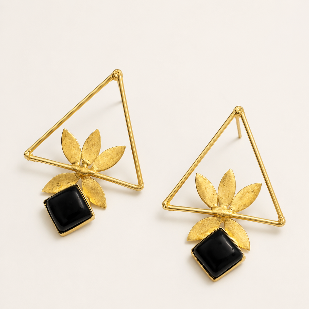 Black brass geometric leaf statement earrings on ivory