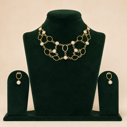 Handmade brass statement necklace and matching earrings on green velvet display