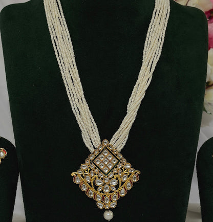 Close-up of Kundan-style pendant with clear decorative stones and pearl-like strands