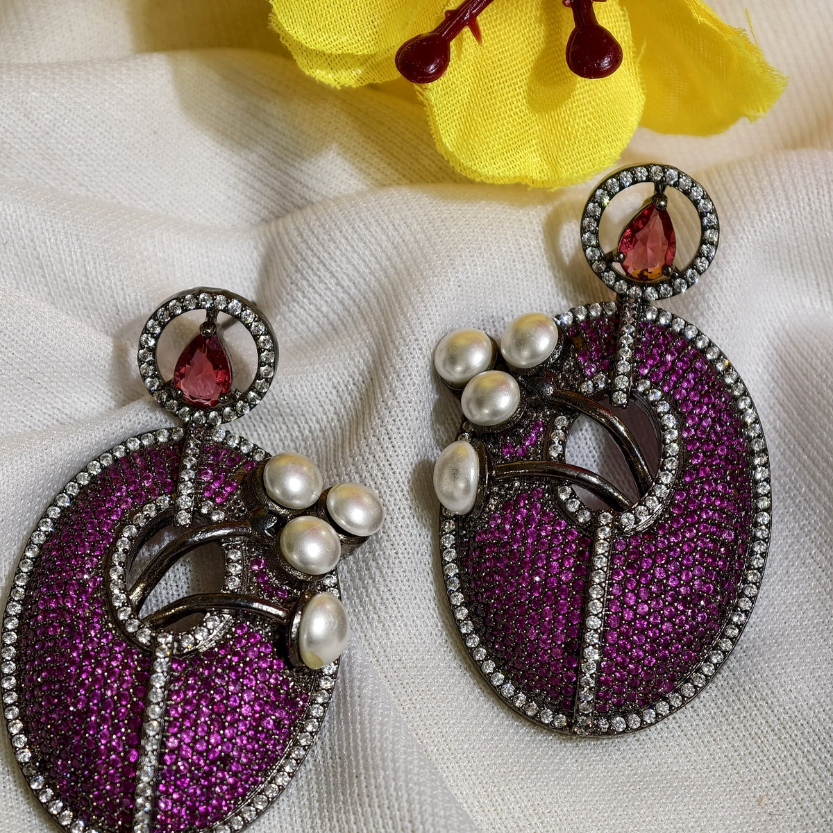 Close-up of Magenta Nano Setting AD Oval Statement Earrings