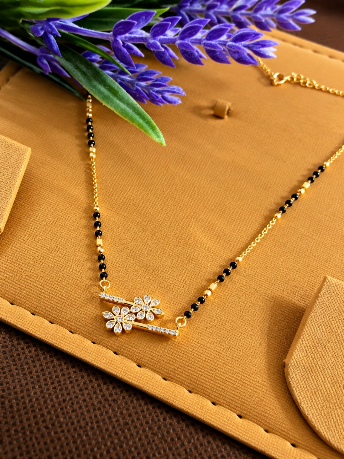 Micro gold-plated black bead mangalsutra with double floral stone bar pendant
