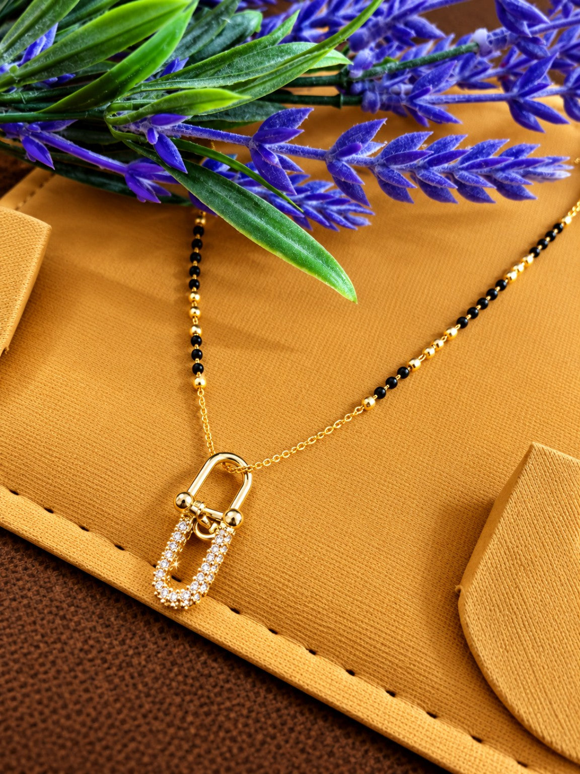 Micro gold-plated black bead mangalsutra with double link pendant and stone-studded lower loop