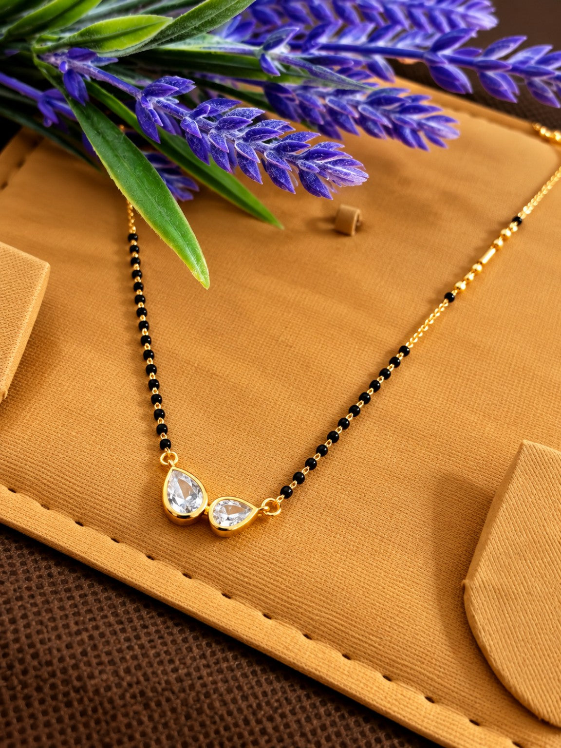 Micro gold-plated black bead mangalsutra with double clear teardrop stone pendant