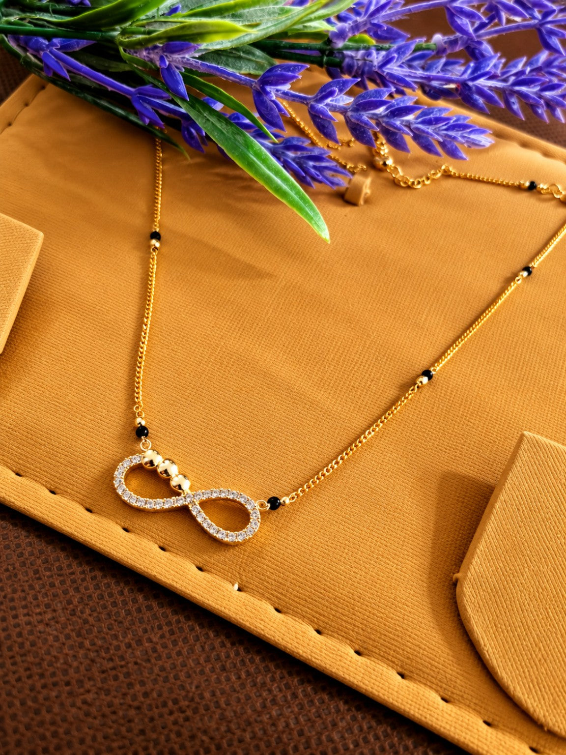Micro gold-plated black bead mangalsutra with stone-studded infinity pendant