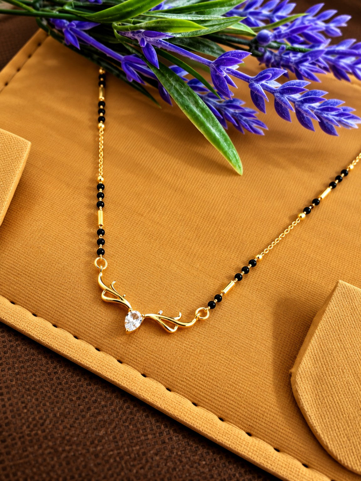 Micro gold-plated black bead mangalsutra with teardrop stone and elegant swirl pendant
