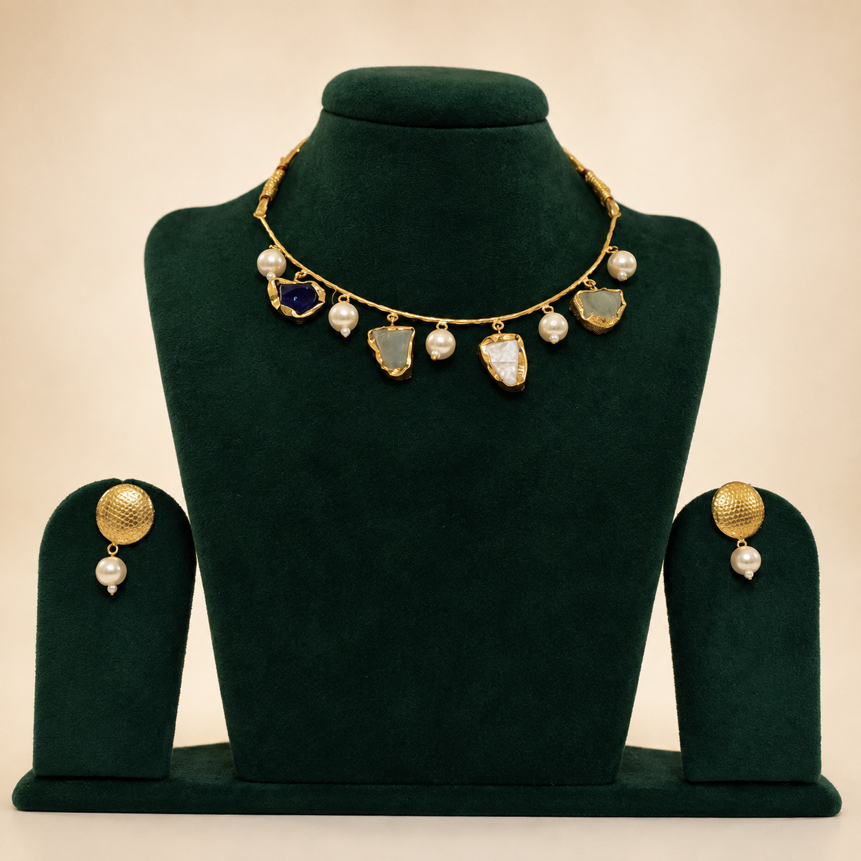 Natural semi-precious stone necklace and earrings on green velvet jewellery bust