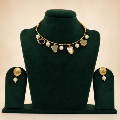 Natural semi-precious stone necklace and earrings on green velvet jewellery bust
