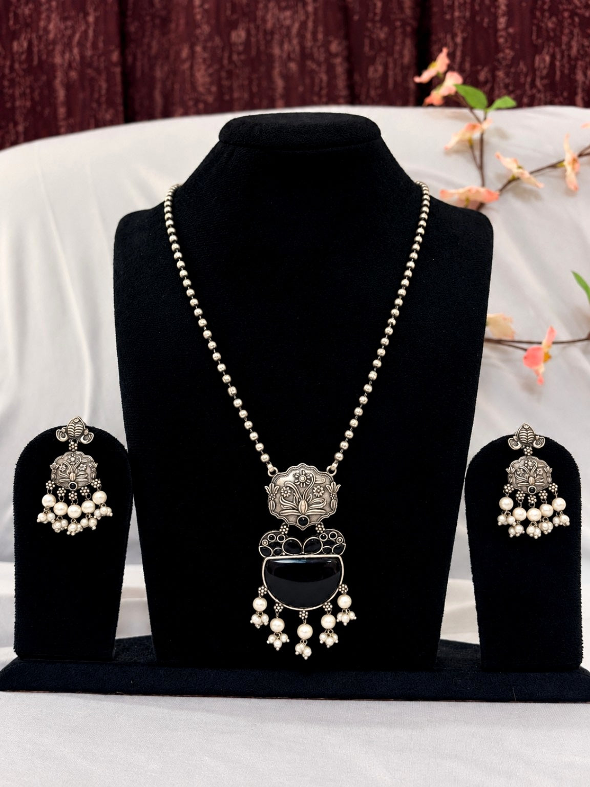 Original display view of oxidised silver replica black stone necklace set with matching earrings