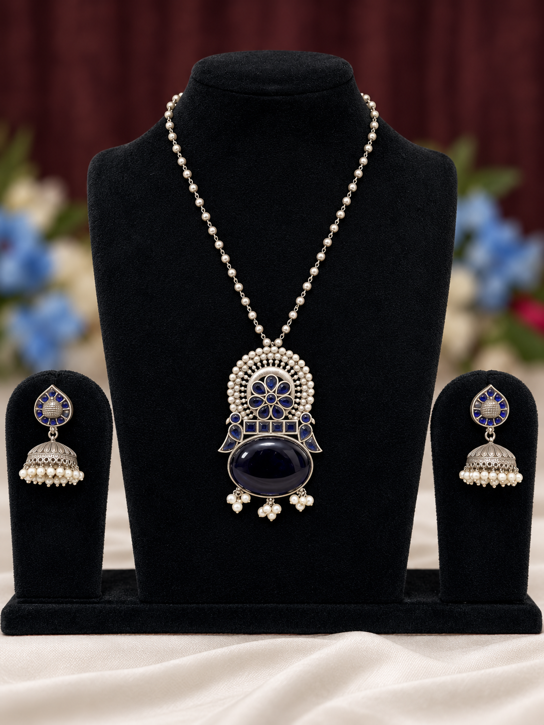 Oxidised silver replica blue stone pendant necklace set with pearl-style chain and matching jhumka earrings