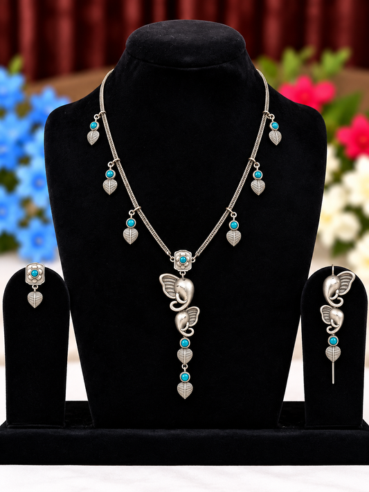 Oxidised silver replica butterfly necklace set with blue bead and pearl-style drops and matching earrings