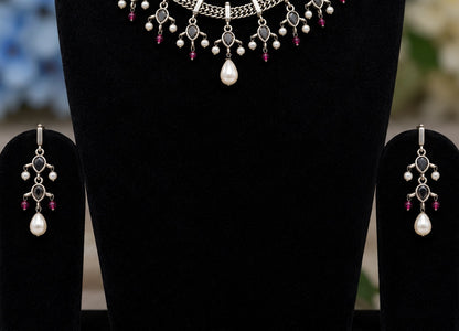 Detail view of oxidised silver replica necklace and matching earrings with pearl drops