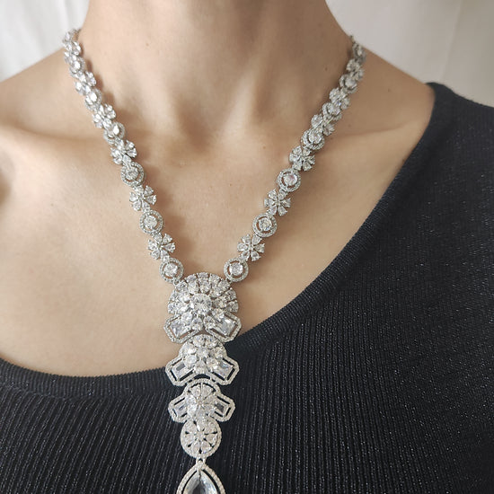 Elegant American Diamond necklace set with floral design, teardrop pendant, and matching earrings – perfect for festive and party wear