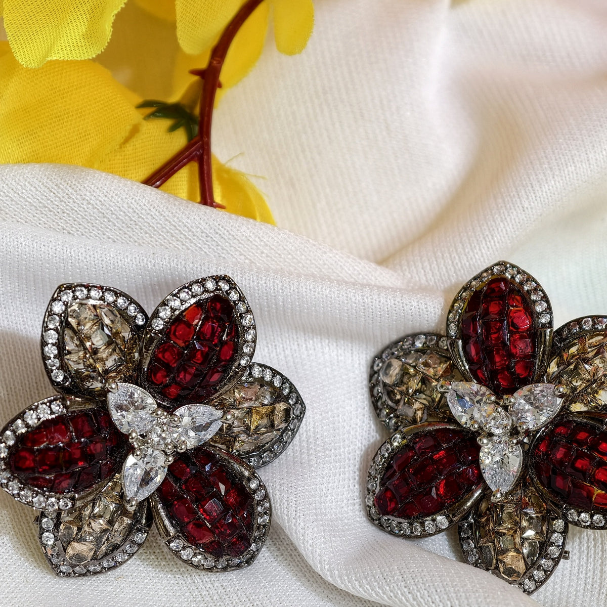 Close-up of Ruby Red Nano Setting AD Floral Stud Earrings