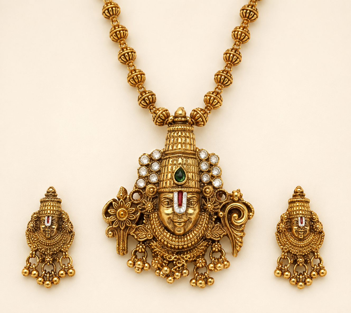 Close detail of Venkateshwara pendant and matching earrings