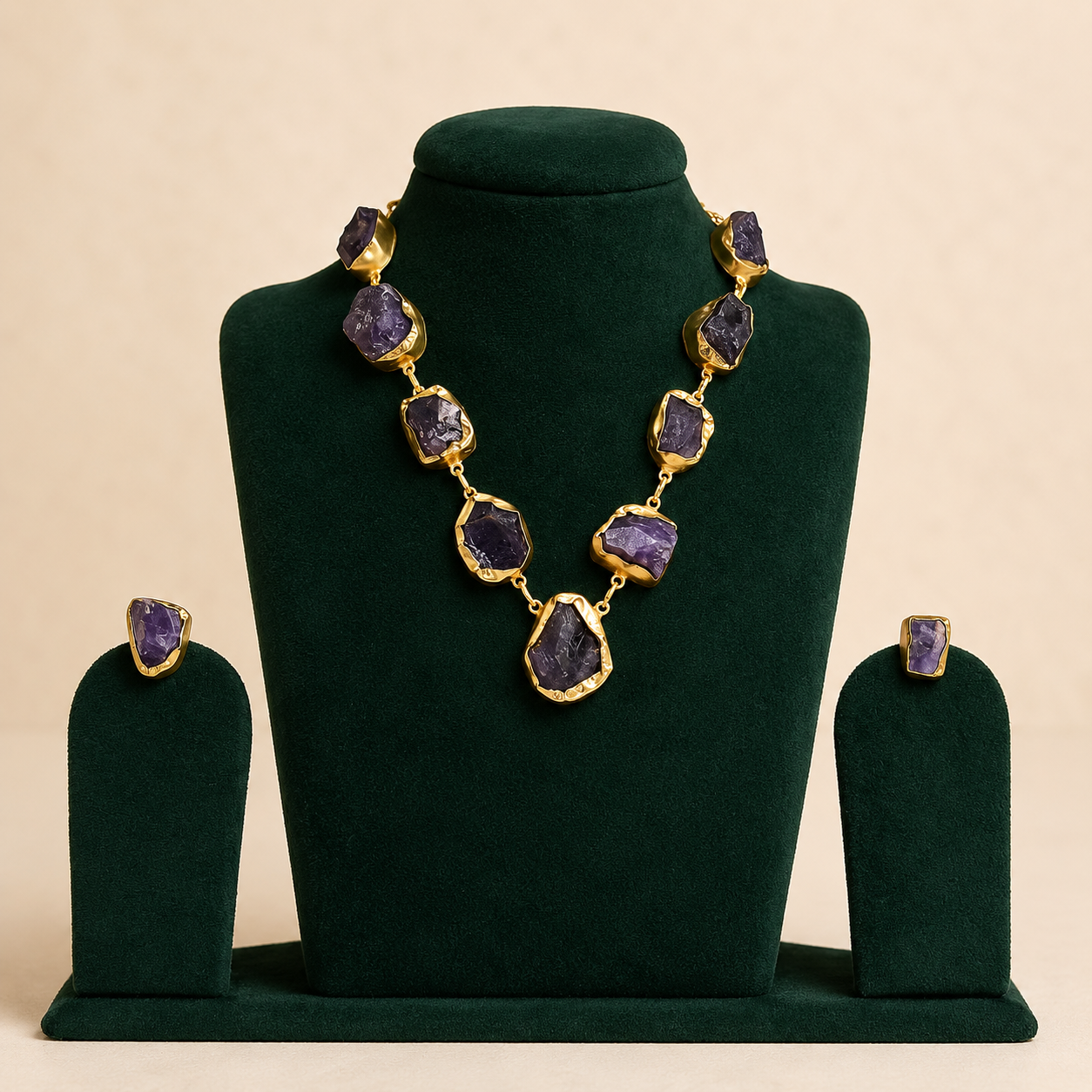 Brass and uncut amethyst statement necklace displayed on green velvet
