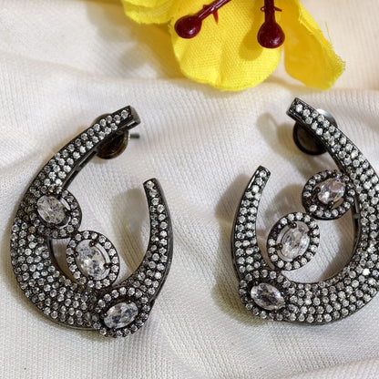 Close-up of White Nano Setting AD Swirl Statement Earrings