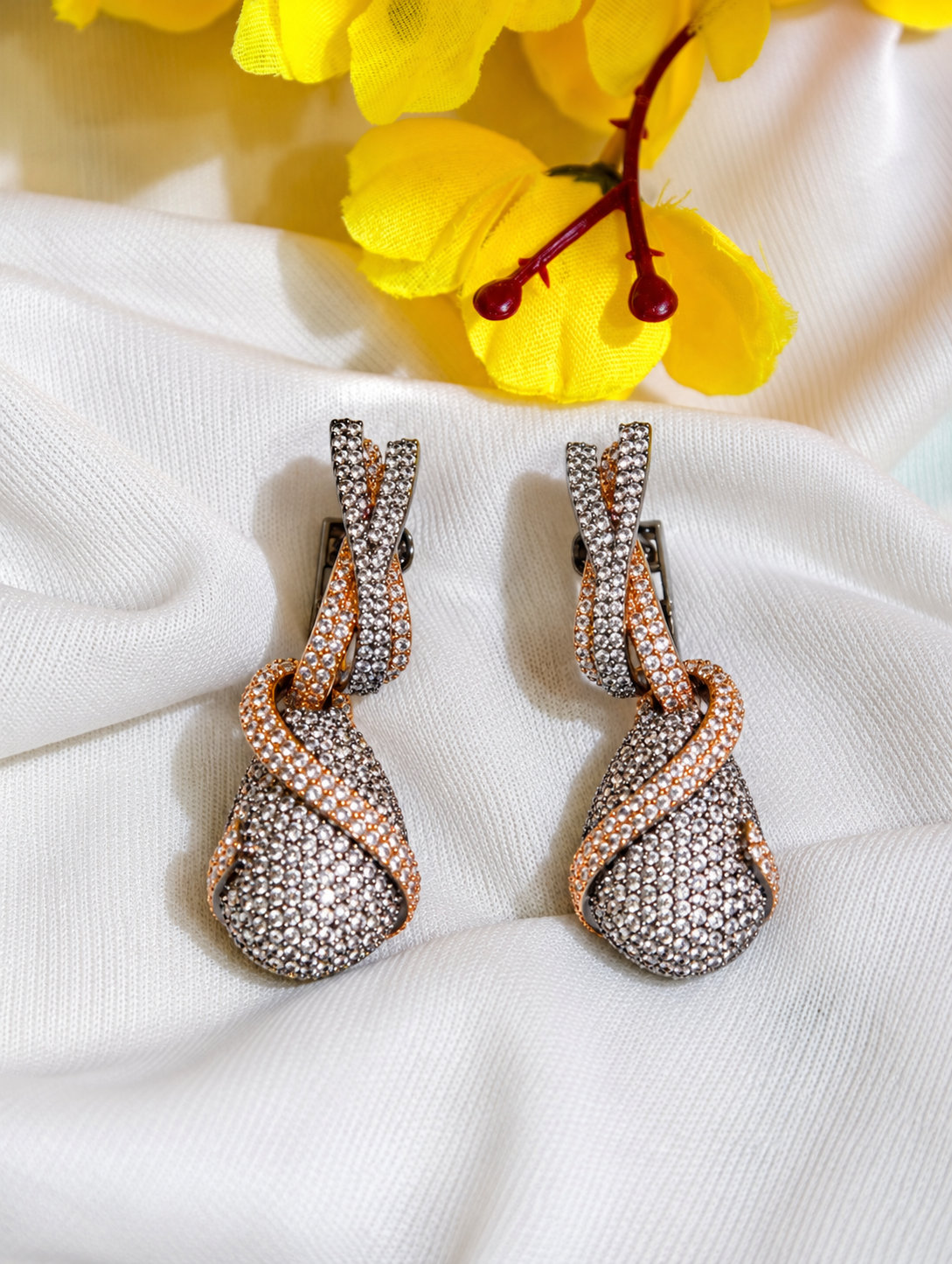Close-up of white nano setting AD twisted drop earrings