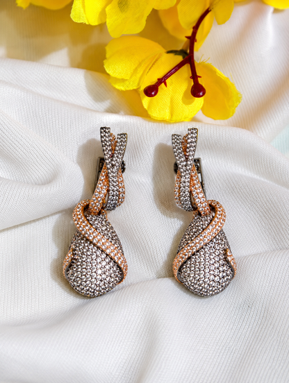 Close-up of white nano setting AD twisted drop earrings